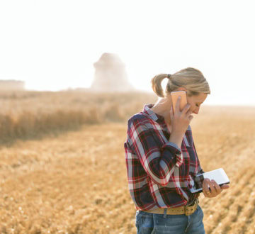 Female farmer with tablet on her wheat field
